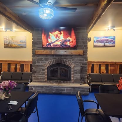 Cozy stone fireplace lounge with comfortable seating at Country Get Away